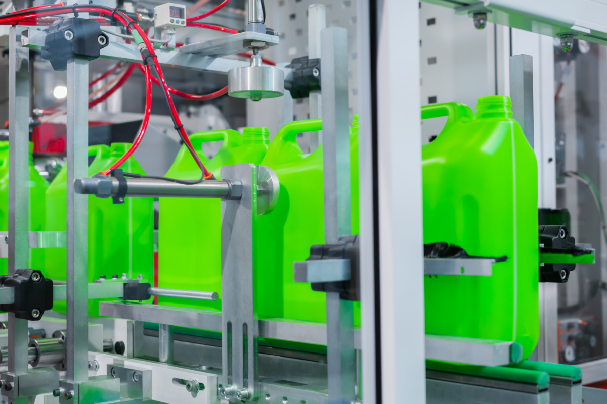 Empty Green Plastic Jerry Cans Moving On Conveyor Belt At Exhibition