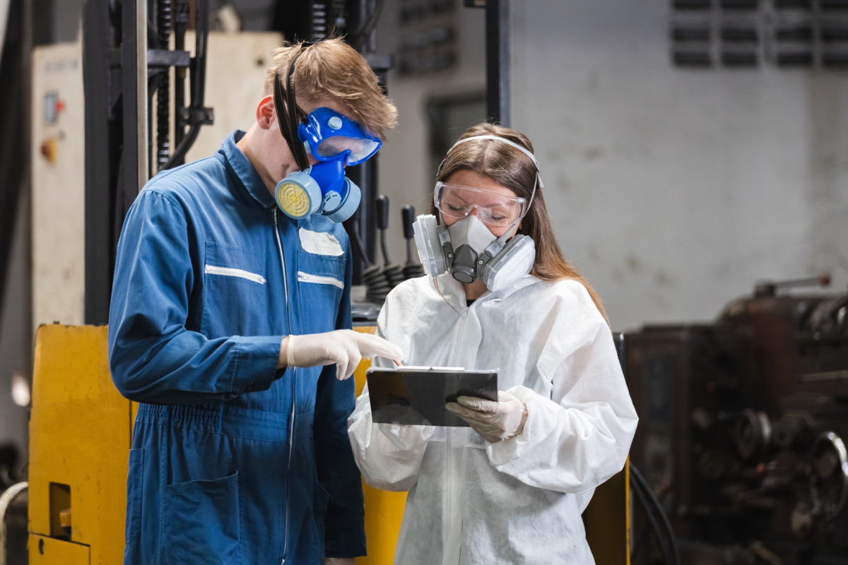 Team Inspector Wearing Chemical Protective Mask And Hazmat Suit Examining Chemistry In Industrial. Analysing Harmful Substances To Human Body And Environment. Research Working