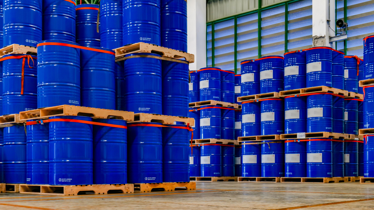 Blue 200 Liter Chemical And Oil Drums Arranged On Pallets. Stored In An Orderly Warehouse. To Wait For Delivery